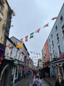 Roadway in Galway, Ireland with different flags strung between buildings