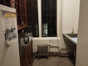 A small kitchen with a sink, microwave, and refrigerator