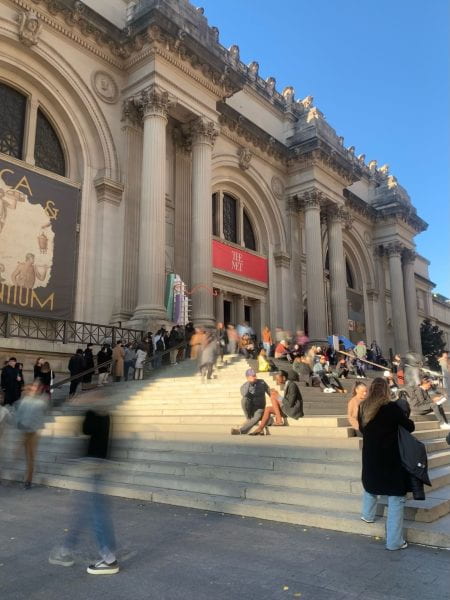The stairs at the Met with people milling around.