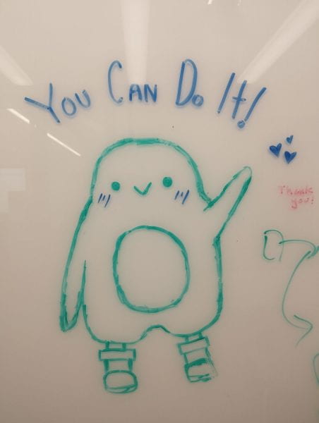 Cartoon penguin drawn on a whiteboard saying "You Can Do It!"