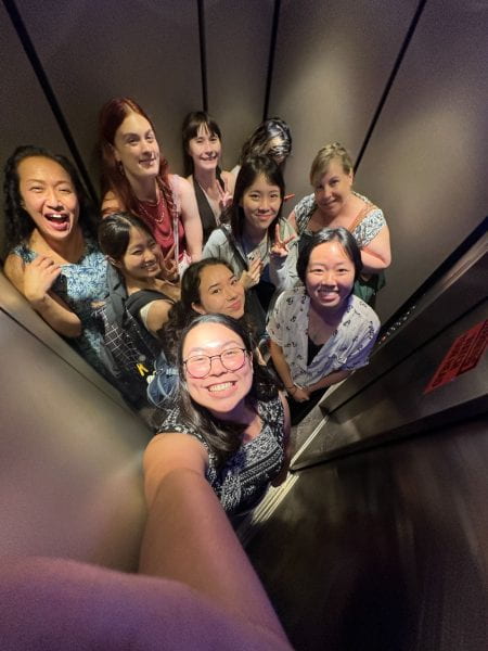 Jade and other students standing in an elevator