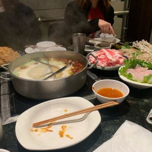 Hotpot with various foods waiting to be cooked.