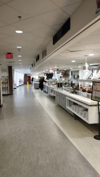 Image of a dining hall, looking down a line of counters and food court areas.