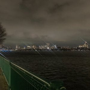 Image of the Boston skyline at night along the Charles River.