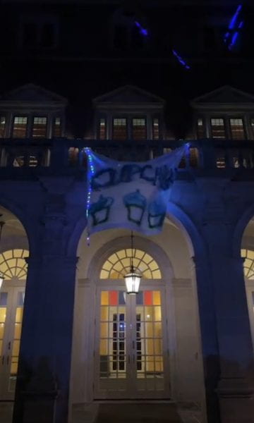 Image of a banner coming down from Alumnae Hall reading CupcakKe.