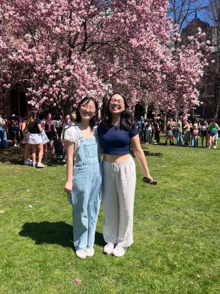 Image of Jade and her friend Vivian in front of a blooming tree.