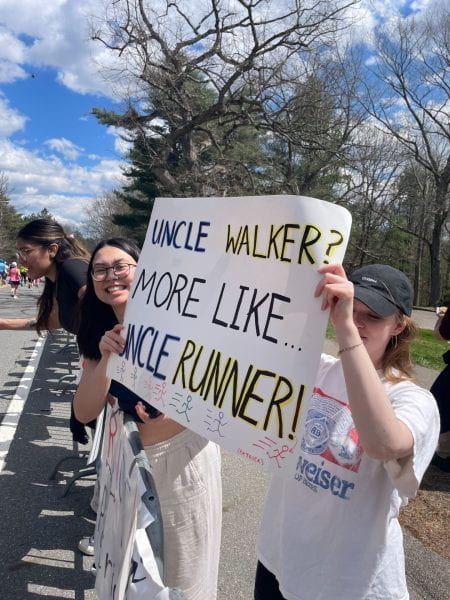 Image of Jade holding a sign reading "Uncle Walker? More like uncle runner!"
