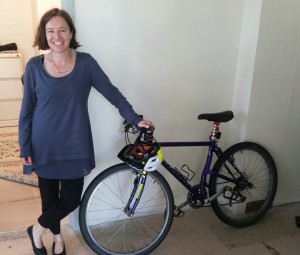 Freedman still commutes seven miles to and from work each day. Here she is pictured with one of the ten or so bikes she owns -- she's not sure of the exact count.